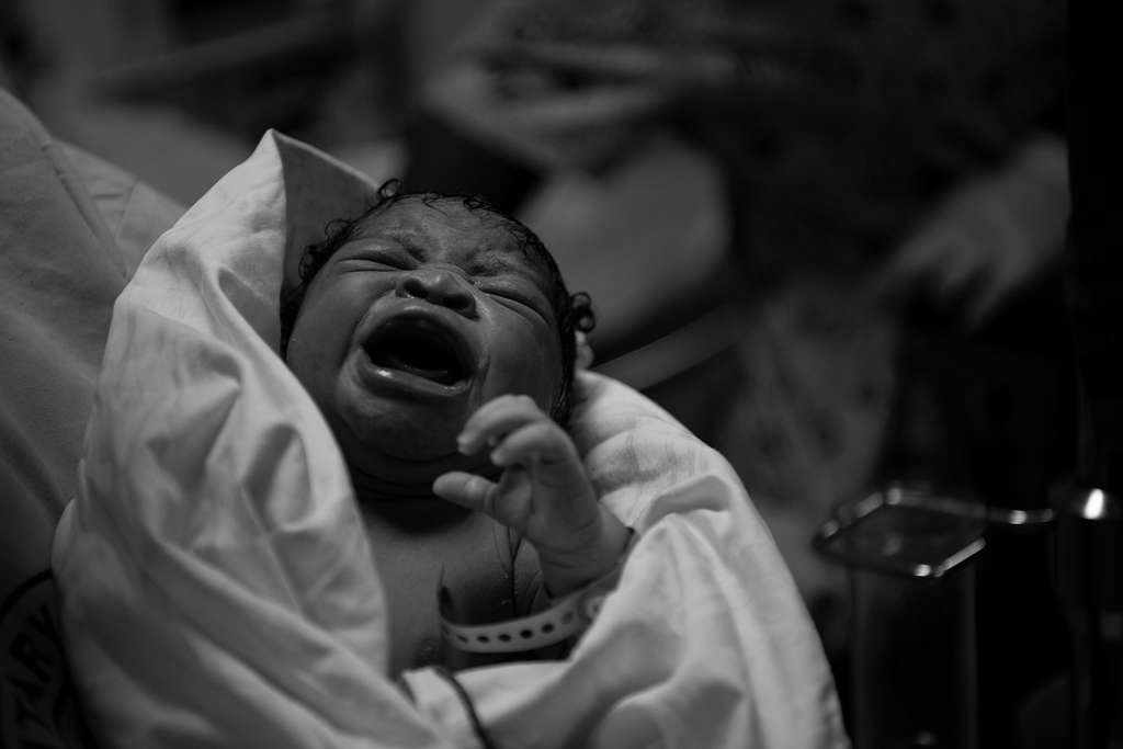 Newborn baby moments after birth, doula-supported delivery