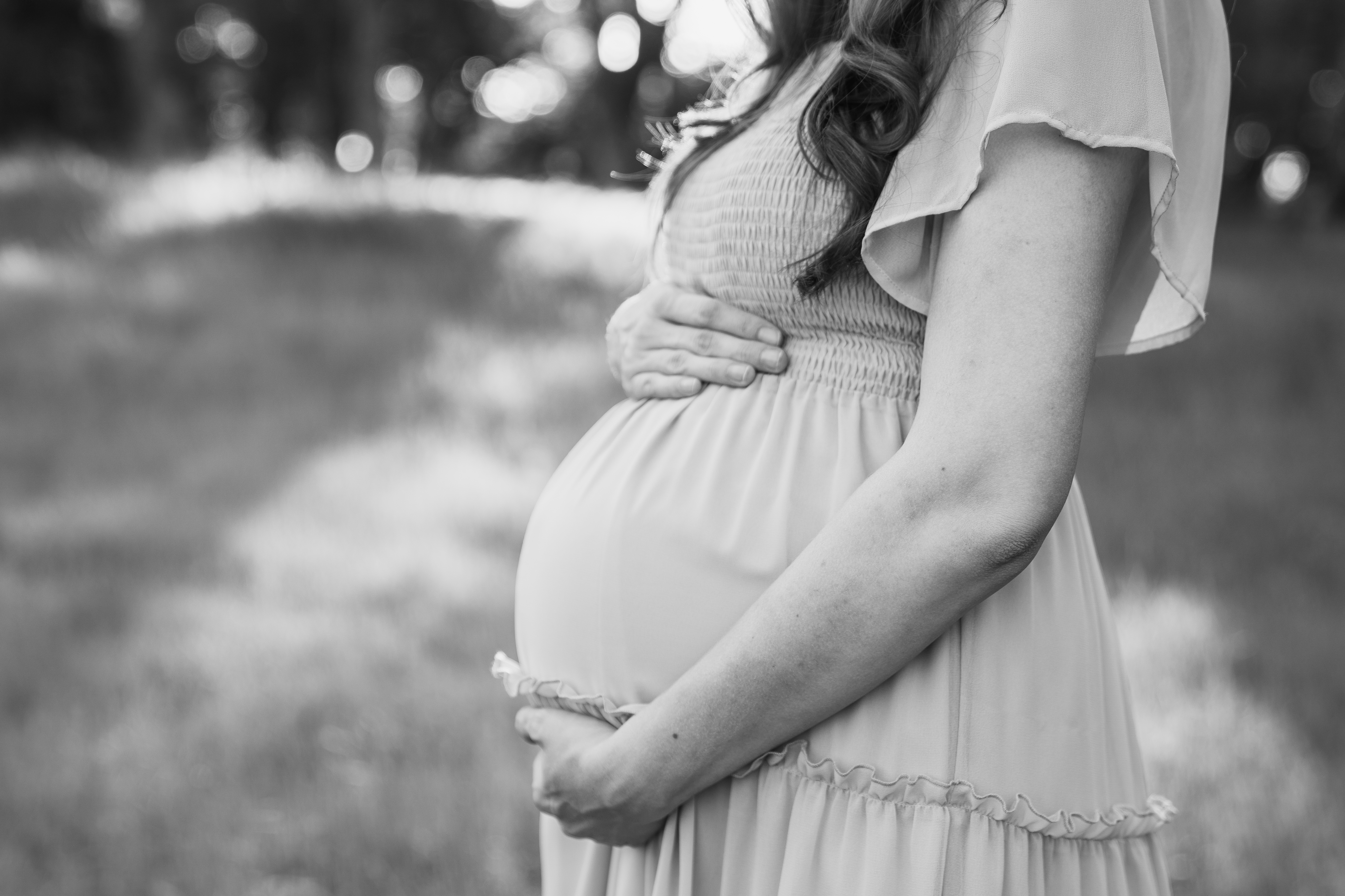 Expectant mother holding her pregnant belly, prenatal support in Sacramento