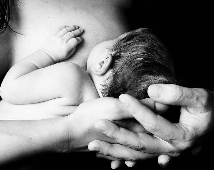 Mother holding her newborn baby skin-to-skin, Sacramento doula support